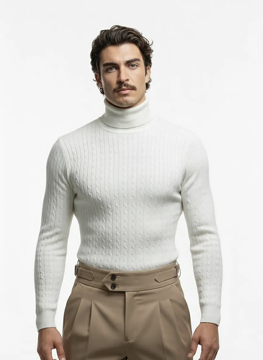 Man wearing a white turtleneck sweater and beige pants on a white background